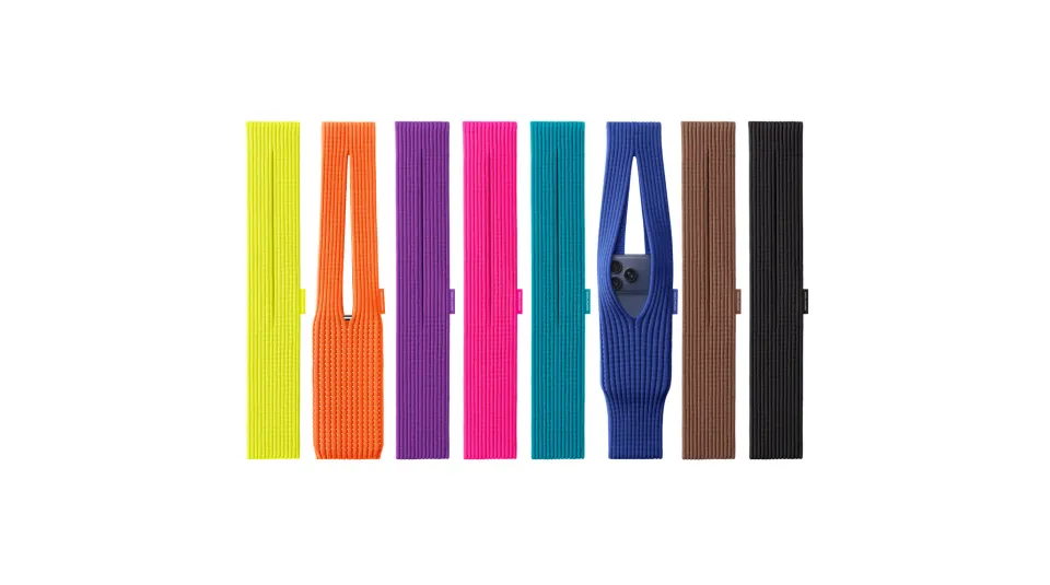 Colorful ribbed fabric phone sleeves in seven hues—yellow, orange, purple, pink, teal, blue, brown, and black—sit in a row; the orange and blue ones are open, the blue holds an iPhone.